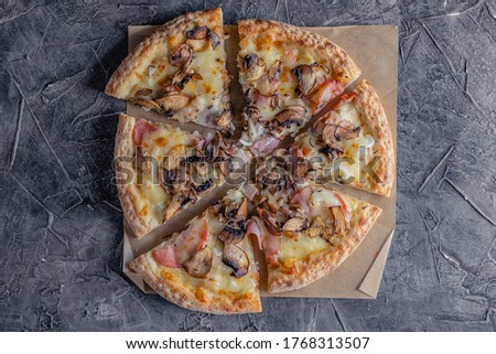 Top view of pizza carbonara with bacon, mushroom and onion on dark grey background