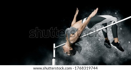 Woman in action of high jump on smoke background. Sports banner. Horizontal copy space background Royalty-Free Stock Photo #1768319744