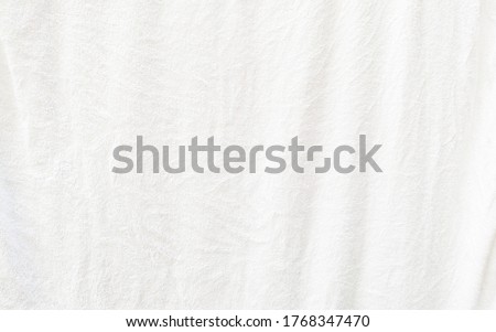 white textured fabric has wrinkles on surface, blank background from white fabric is dried up
