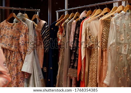 Hanging beautiful indian dresses different colors and decoration at market, shop, boutique, bazaar, fashion clothes designer collection Royalty-Free Stock Photo #1768354385