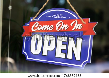 Storefront Open Sign Through Window.