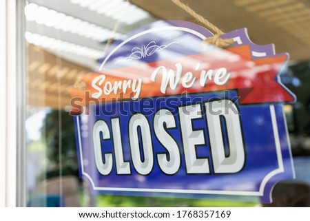 Storefront Closed Sign Through Window.