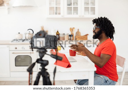 Handsome man recording video business course at home