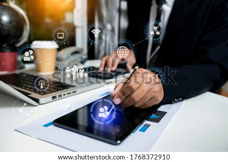 Businessman hands working on tablet computer with digital marketing virtual chart, Abstract icon, Business strategy concept.