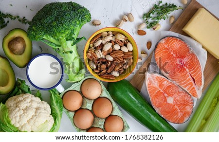 Flexitarian diet. Keto diet. A set of products of the healthy food. Green vegetables, avocado, nuts, salmon, eggs, milk products. Healthy balanced food concept, flat lay Royalty-Free Stock Photo #1768382126