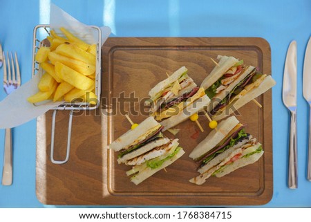 different kind of sandwiches with fries and souces
