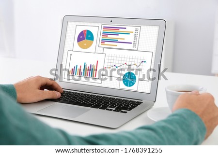 Value concept. Man working with laptop at table indoors, closeup