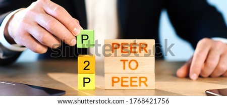 p2p concept. man stacks wooden blocks in the inscription p2p