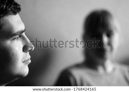 The guy and the woman are laughing in conversation. Conversation. Close-up. Blurred background for presentation about communication. Human relations. Mother with her son. Separation. BW. Defocused