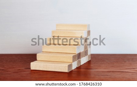 Wooden blocks as a staircase stacking. Career ladder concept for successful business development.