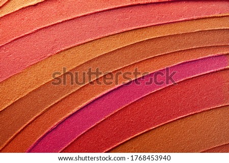Red and pink and brown holographic shimmering smeard lipstick background texture smudge
