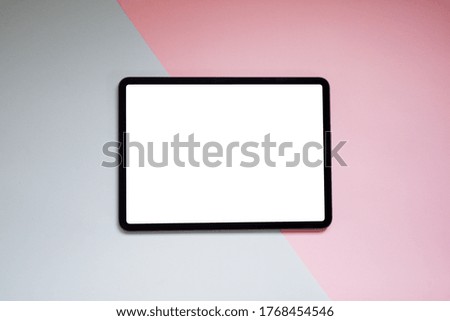 Top view image of white blank screen computer tablet on table two tone