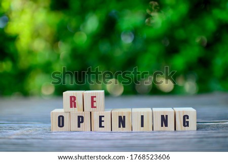 Wooden cubes with REOPENING word. Adapting to new life or business post-lockdown after coronavirus pandemic.Turn to next normal in financial concept. Royalty-Free Stock Photo #1768523606