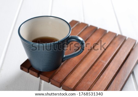 Tea in a blue cup on a white background
