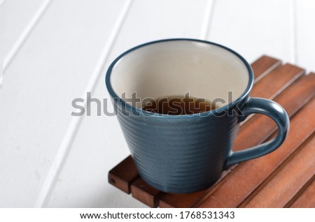 Tea in a blue cup on a white background