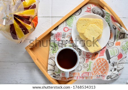 Dry bread on plate and a cup of tea