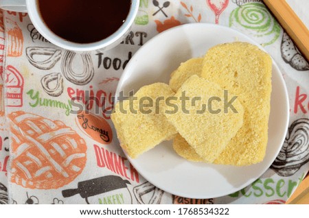 Dry bread on plate and a cup of tea