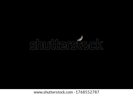 Half moon on the dark sky Capture my DSLR Camera.Real Picture of Moon.the Moon without cloud at night.Serenity nature background,outdoor at gloaming.beautiful nature landscape fantasy.Peaceful sky.