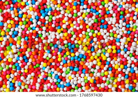 close up colorful texture of sparkling sugar bead background