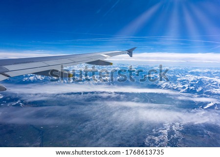 Flying over the clouds Inflight airplane wing