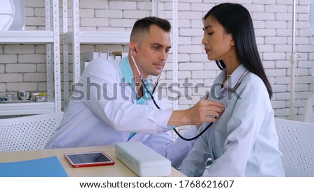 Doctor in professional uniform examining patient at hospital or medical clinic. Health care , medical and doctor staff service concept.