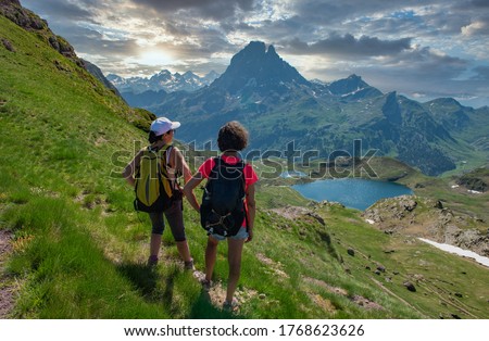 two hiker women in path of Pic du Midi Ossau in the french Pyrenees mountains