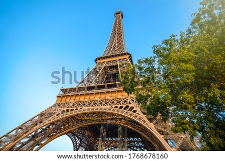 Detail bottom view of  Eiffel Tower on the blue sky background in sunset light