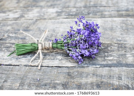 small lavender bouquet on old rustic wooden table, banner copy space, fresh aromatic herbs