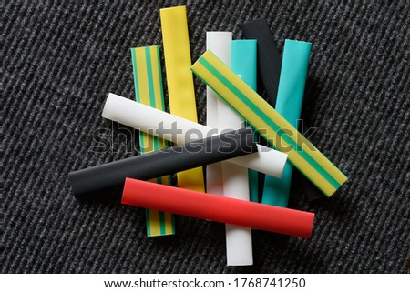 Background. The geometric shape of the colored heat-shrink tubing on the black.