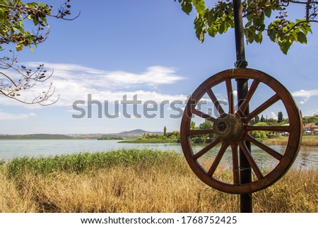 old horse carriage wheel decorative, the view of the Gölyazı in  the back