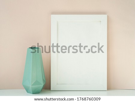 White empty frame, vase and flower mockup with light beige background
