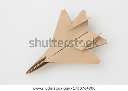 Origami paper airplane mockup. Selective focus. Light background