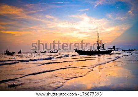 silhouette to the wooden fishing boat in the twilight