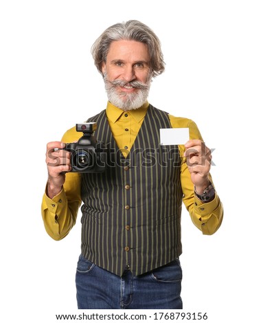 Handsome senior photographer with business card on white background