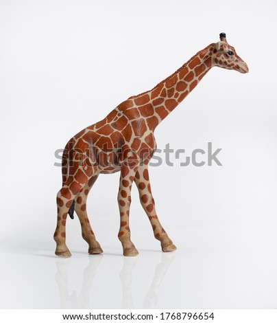 Plastic toy giraffe with reflection