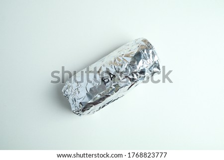 isolated image burrito wrap in aluminium foil. Royalty-Free Stock Photo #1768823777