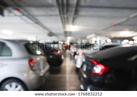 Blur image of car parking area background.