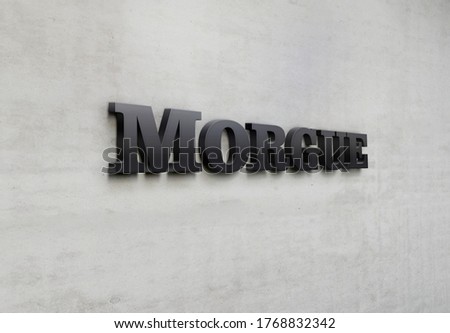 A building metal signage that says 'Morgue'.