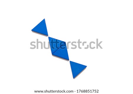 Wooden triangles of blue color compiled in a pattern in the form of candy.