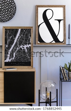 Scandinavian home interior of living room with two mock up poster frames, wooden commode, design black lamp, plants, decoration, carpet and elegant accessories in stylish home decor. 