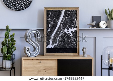 Modern scandinavian home interior with mock up poster frame, design wooden commode, big cement letter, cacti, plants, decoration, shelf and personal accessories in stylish home decor. 