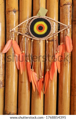 divine eye of providence dreamcatcher with colored feathers on a