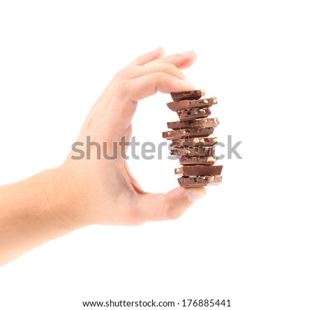 Hand holds milk chocolate with nuts.  isolated on a white background