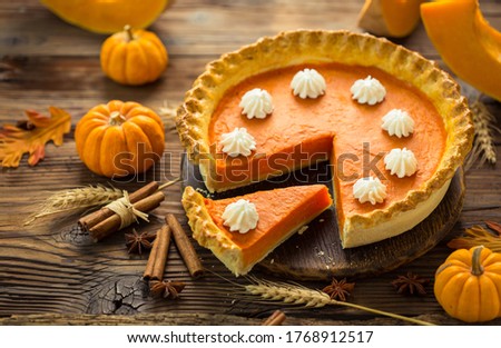 Fresh homemade pumpkin pie on the wooden table