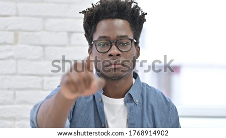 Serious Young African Man Pointing Finger