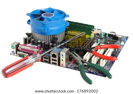Tools and motherboard on a white background