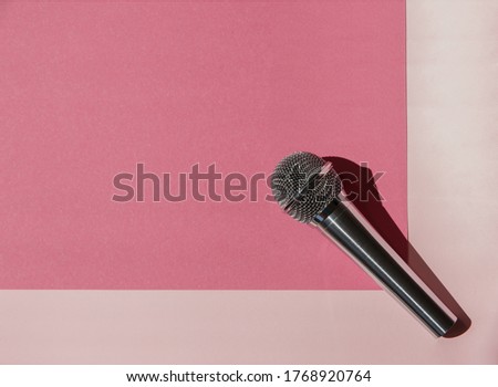 The microphone is on a bright pink background. The view from the top.
