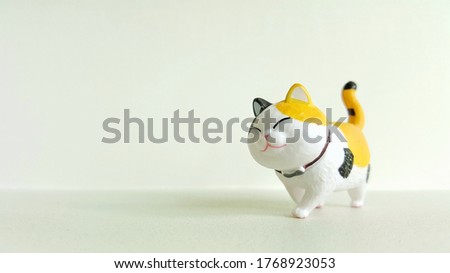 Cute Japanese cat doll on white background.