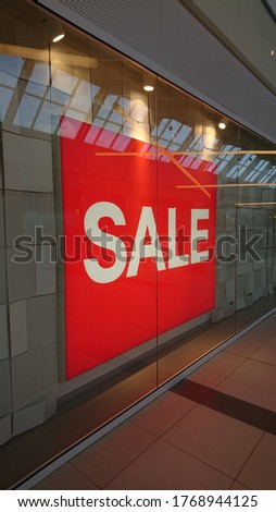 Sale banner in shopping mall store shopwindow 