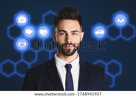 Young man and different icons on dark blue background. Insurance concept